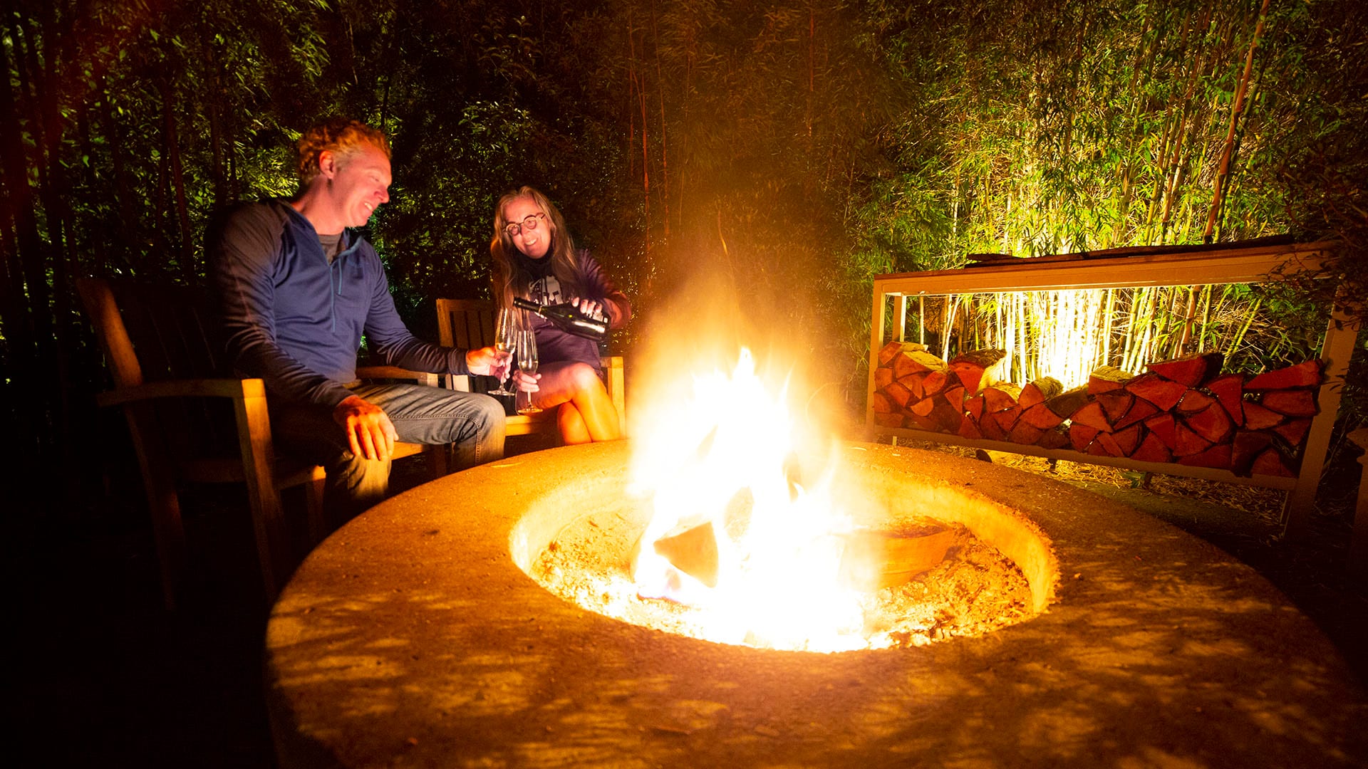 Brad and Tonya Clement enjoy champagne by firelight at their glamping accommodations.